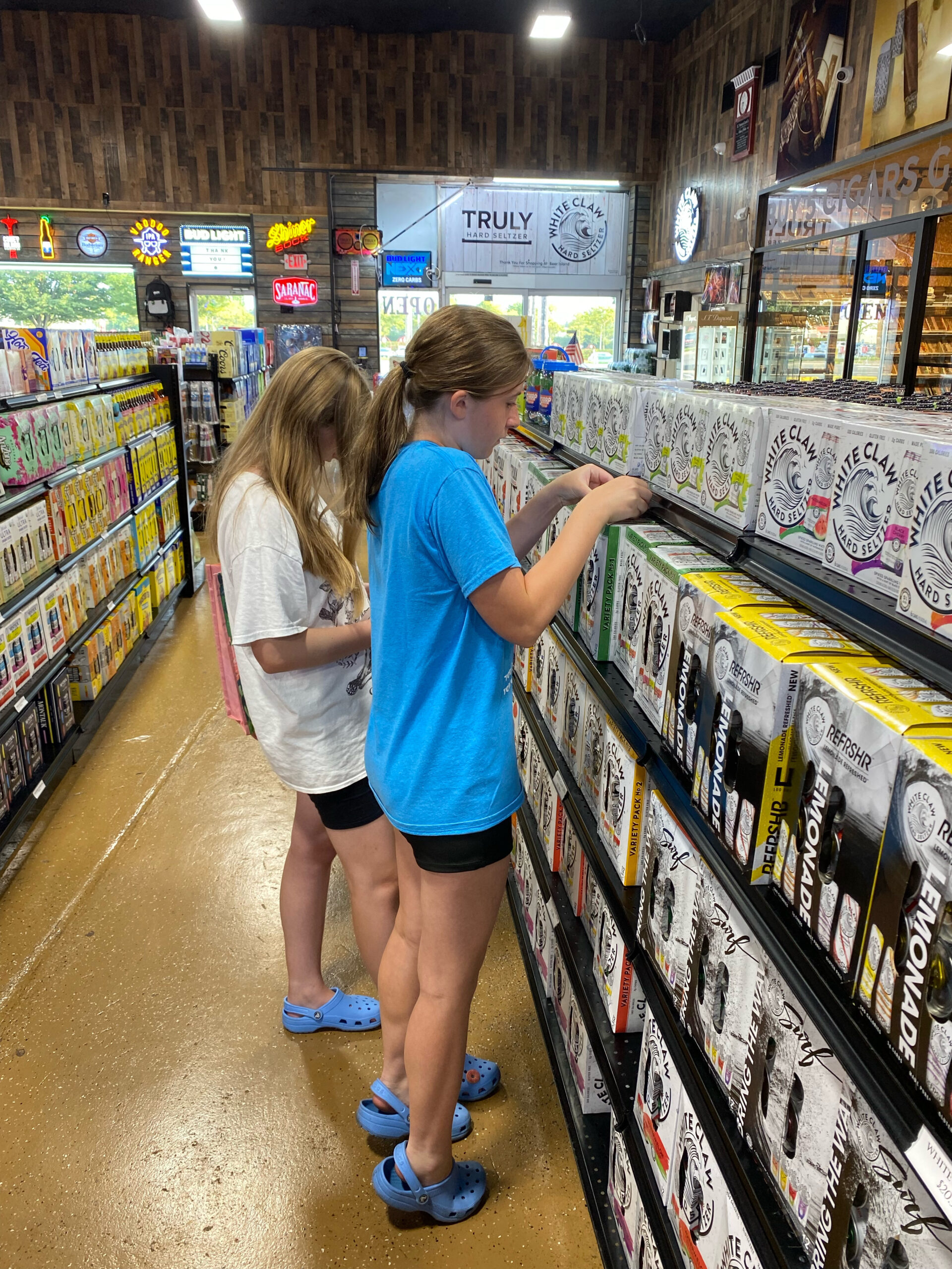Students placing prevention messaging on alcohol products at local retailer